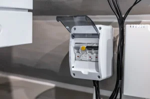 a white electrical box with wires attached to it photo